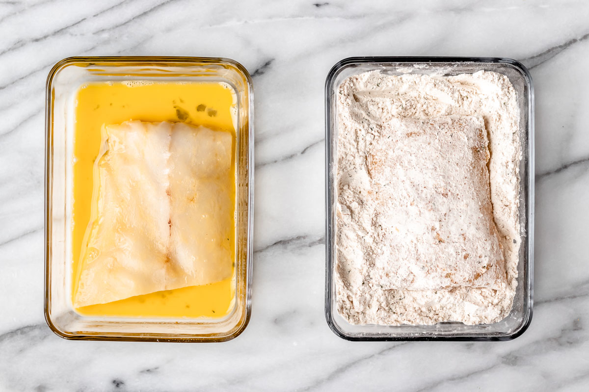 A piece of cod in a bowl of egg and a piece of cod in a bowl of seasoned flour.