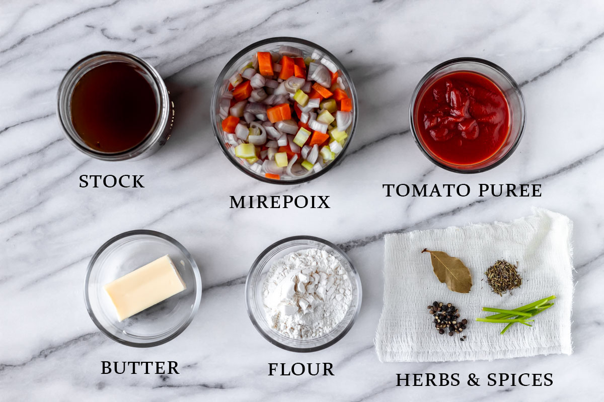 Ingredients needed to make espagnole sauce on a marble background with text overlay.
