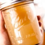 Homemade chicken stock in jars with text overlay.