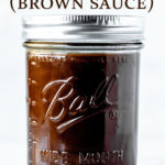 Espagnole sauce in a glass jar with text overlay.