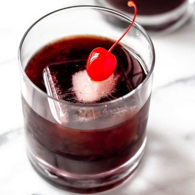 Close up of a French Connection cocktail on a white background.