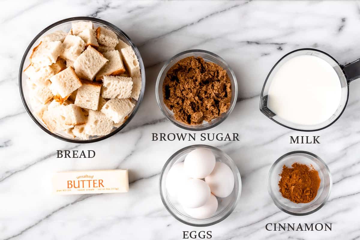 Ingredients to make a French Toast Casserole on a marble background with text overlay.