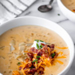 Loaded Potato Soup in a white bowl with text overlay.