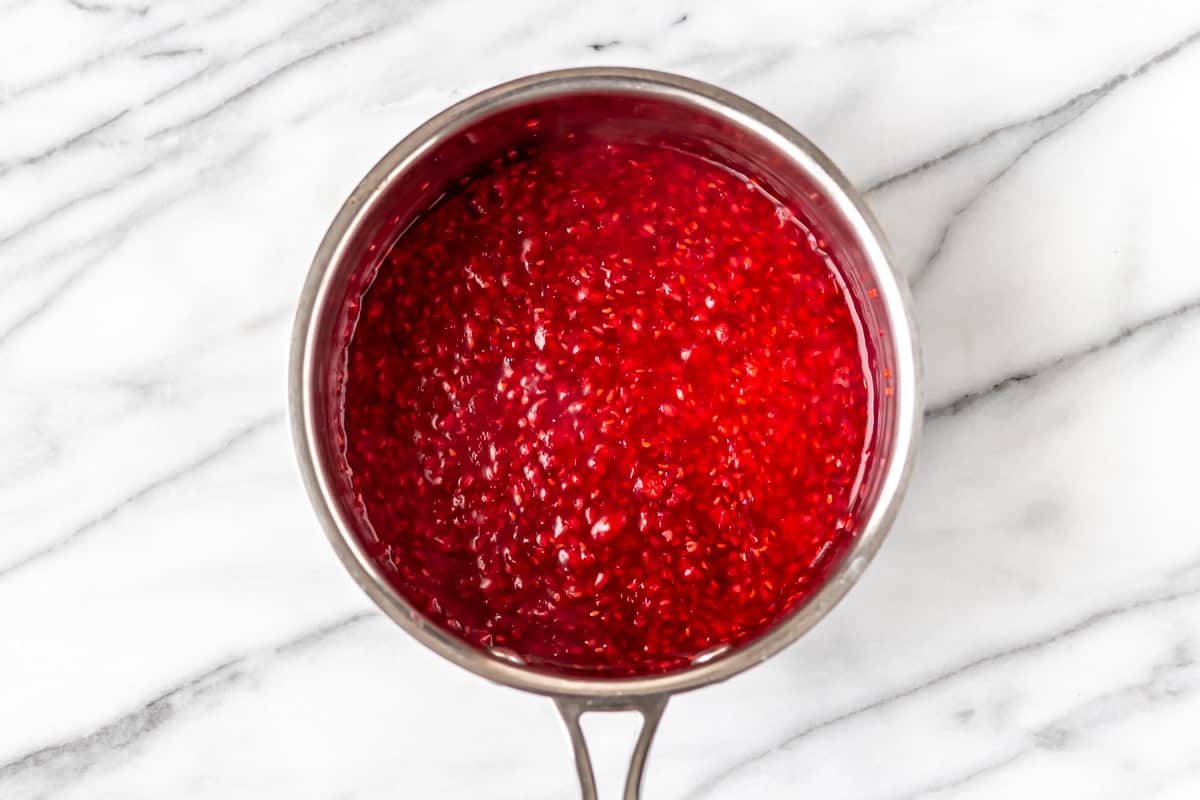 Raspberry sauce in a saucepan.