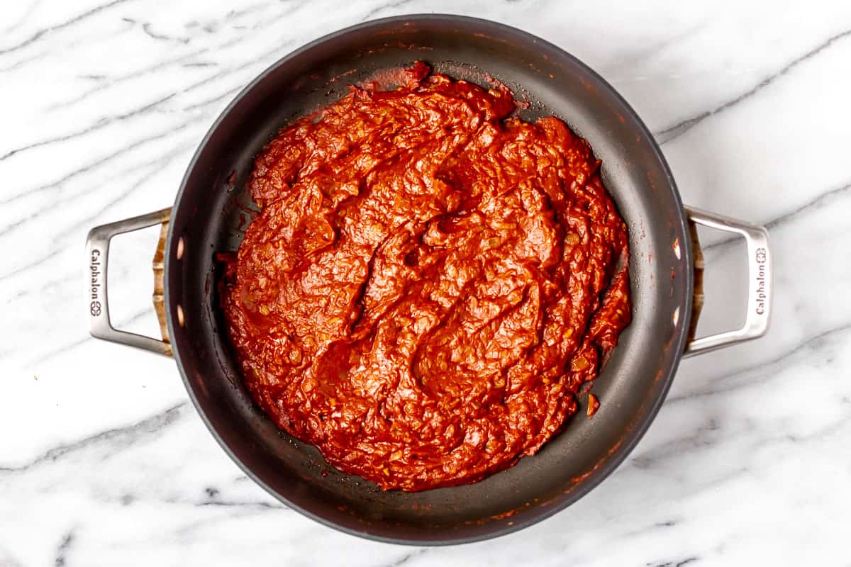 Thickened spiced tomato sauce in a black skillet.