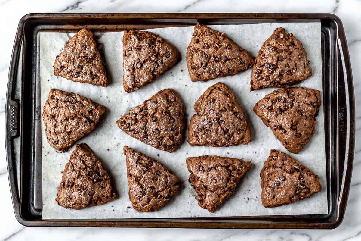 Baked chocolate scones on a sheet pan.