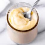 Vanilla Pastry Cream in a glass jar with a spoon.