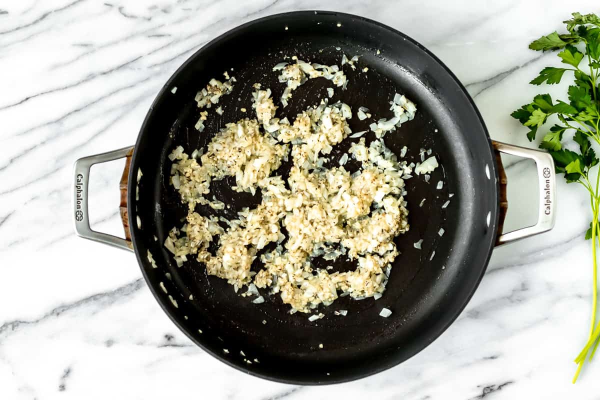 Onion and garlic cooking in a skillet.