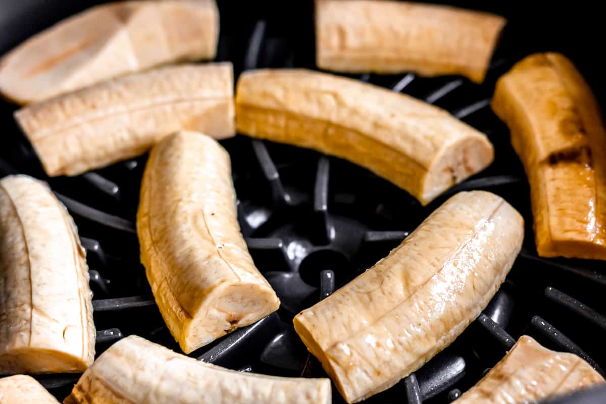 Raw plantains on a grill.