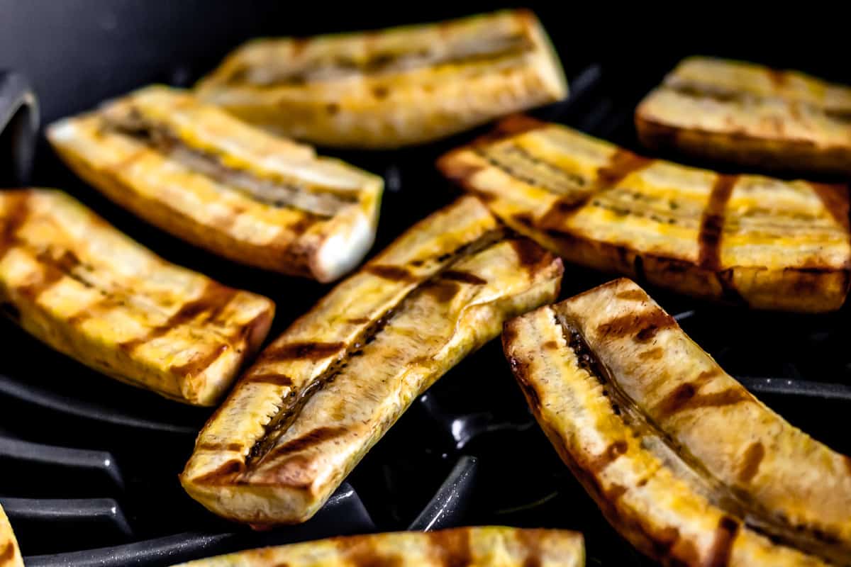 Grilled plantains on a grill.