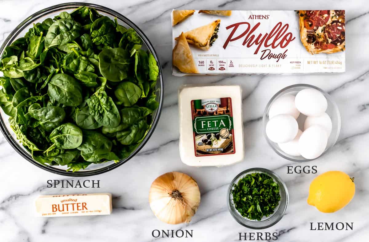 Ingredients needed to make spanakopita with text overlay.