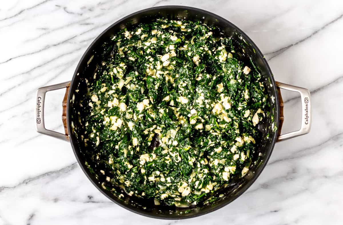 Spanakopita filling in a large skillet.