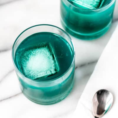 Close up of two blue pineapple cocktails.