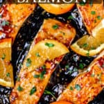 Orange glazed salmon is a cast iron pan with text overlay.