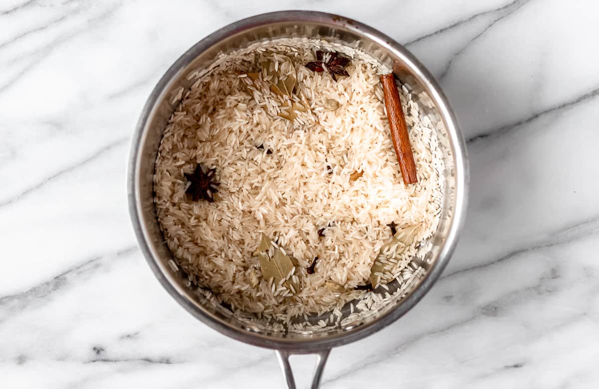 Rice and spices in a saucepot.