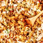 Ground beef pasta skillet with text overlay.