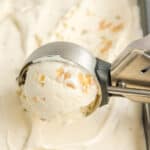 Close up of maple walnut ice cream being scooped out with an ice cream scoop with text overlay.