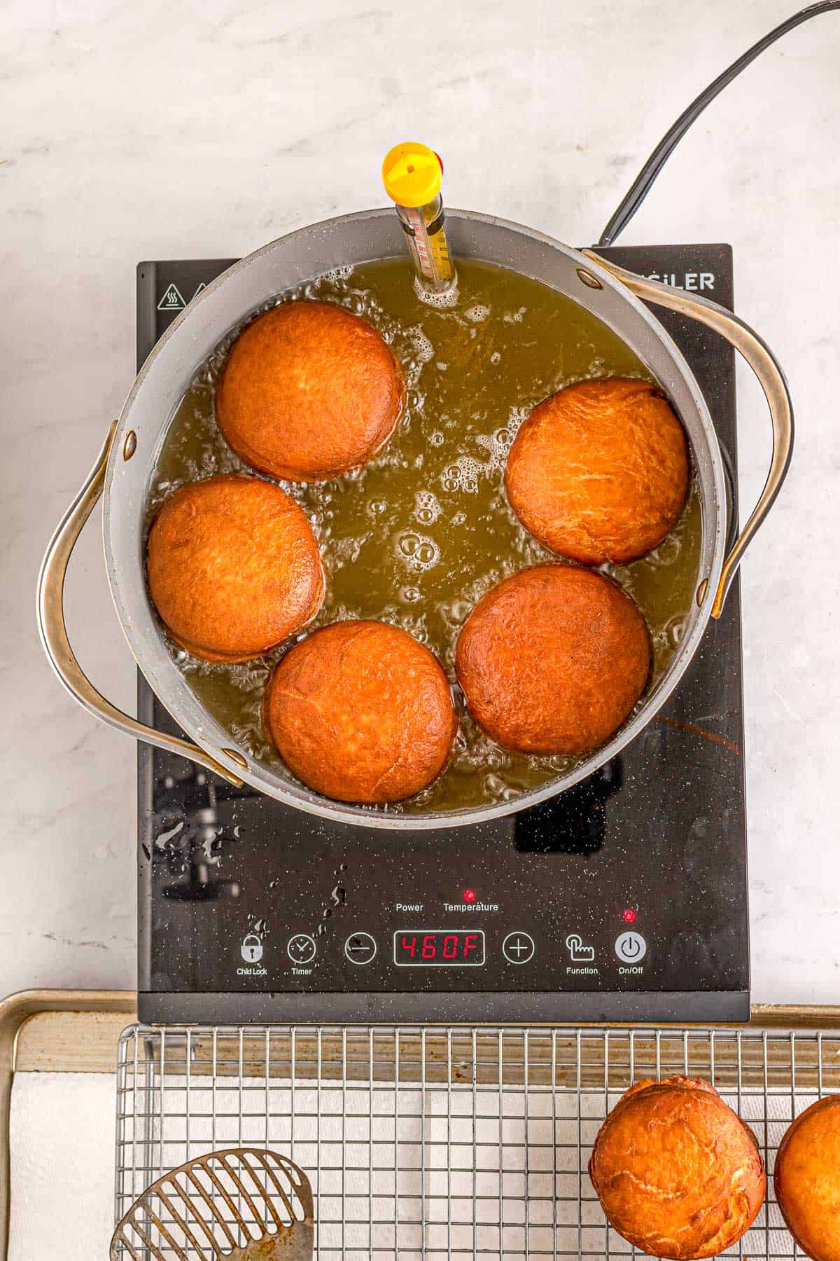 Fried donuts in oil.