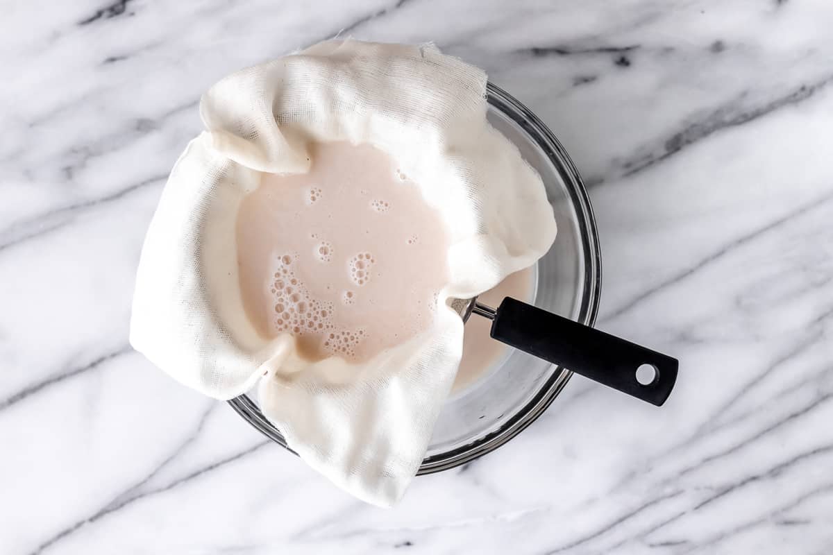 Straining horchata through cheese cloth..