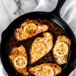 Greek chicken in a skillet with text overlay.