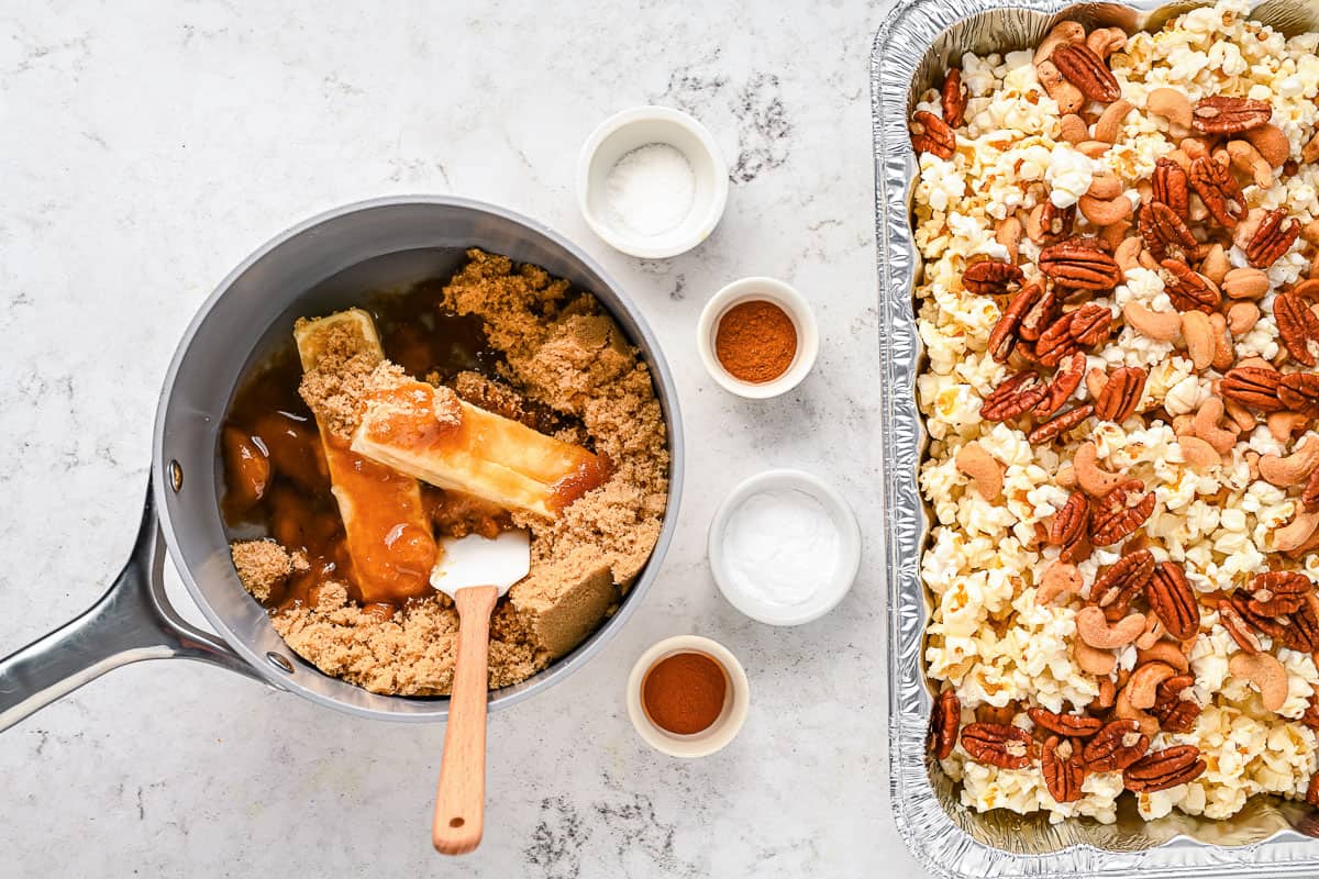 Popcorn and nuts in a disposable tray and ingredients to make caramel in a sauce pan.