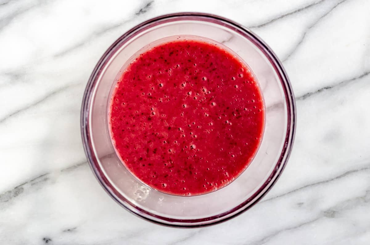 Cranberry sauce, dijon and apple cider vinegar whisked together in a glass bowl.