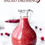Cranberry salad dressing in a carafe with text overlay.