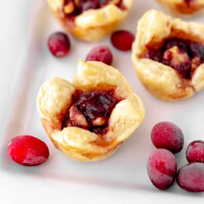 Cranberry walnut cups on a white serving tray.