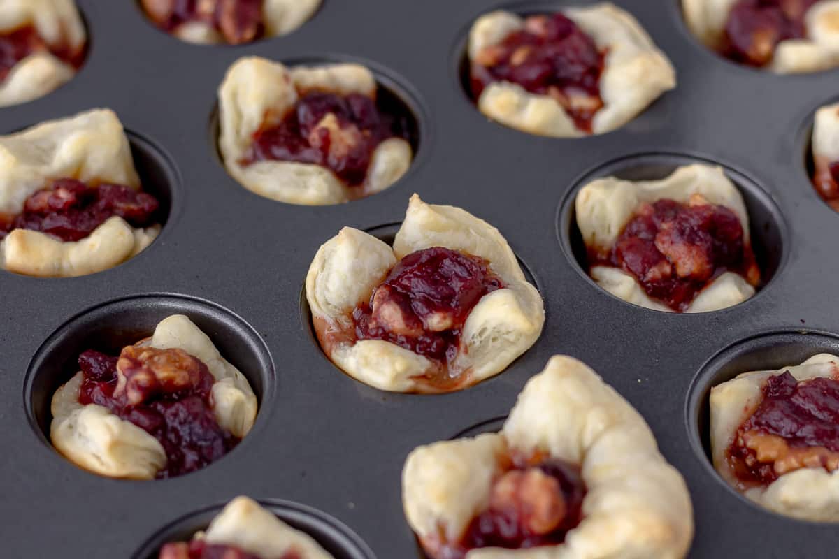 Baked cranberry walnut puff pastry cups in the mini cupcake pan.