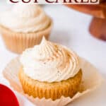 Two eggnog cupcakes, one with the wrapper pulled back and a red ribbon with text overlay.