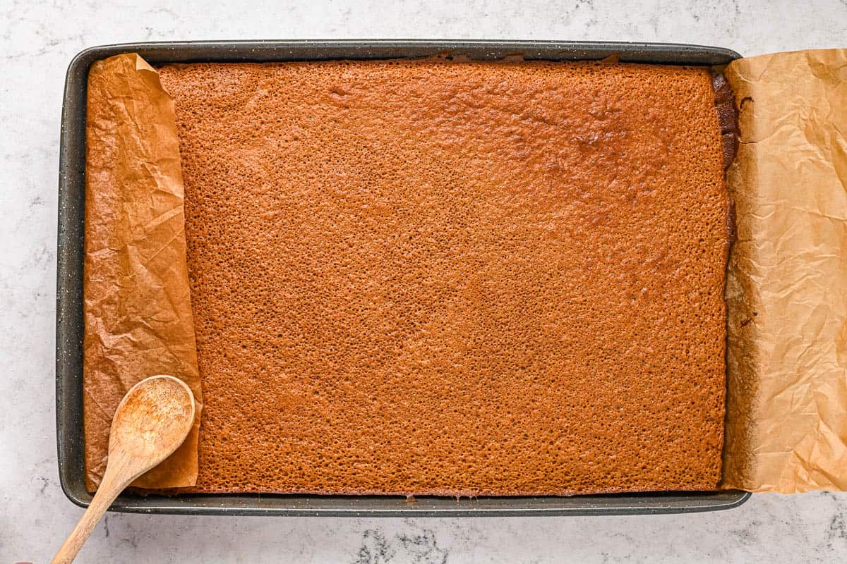 A baked gingerbread cake in a sheet pan.