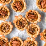Close up of mini pecan pies with text overlay.