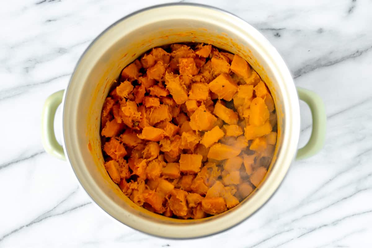Honeynut squash cubes cooked in a large stockpot.