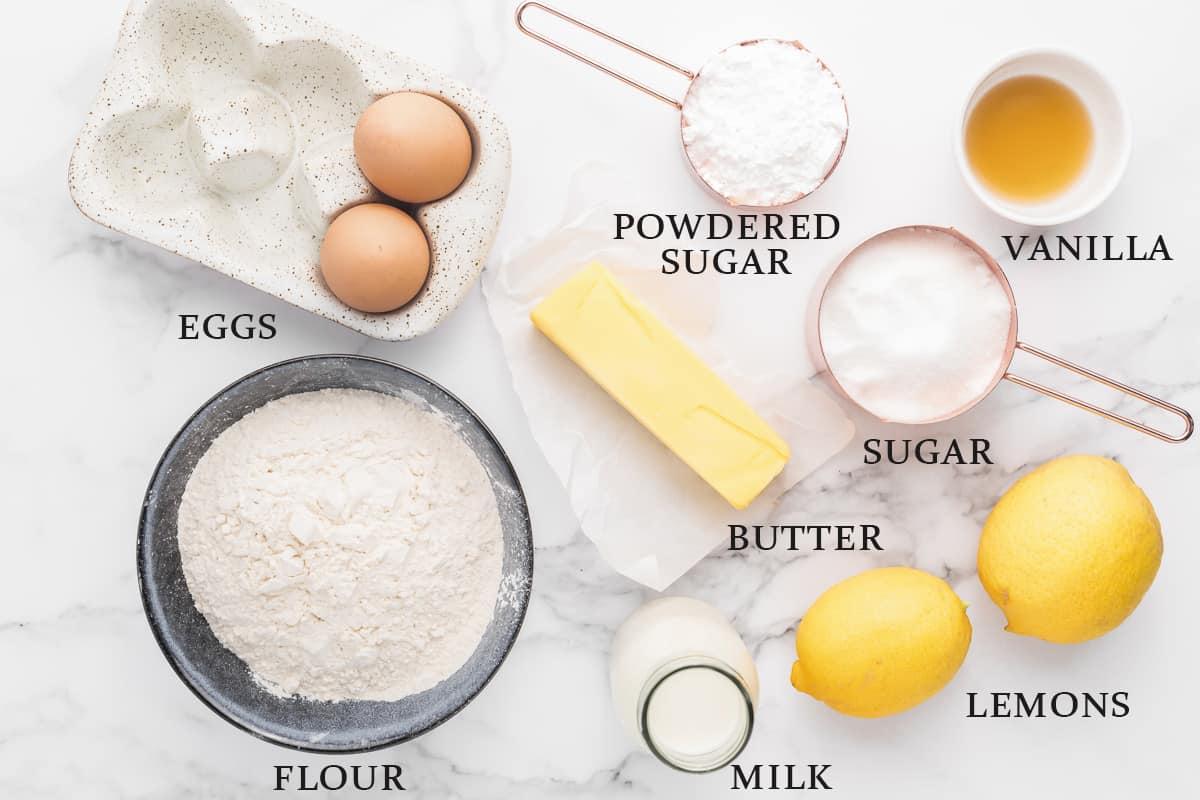 Ingredients to make a lemon drizzle cake laid out on a white background with text overlay that says the name of each one.