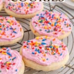 Close up of sugar cookies with pink icing and rainbow sprinkles. Text overlay reads Lofthouse Cookies.