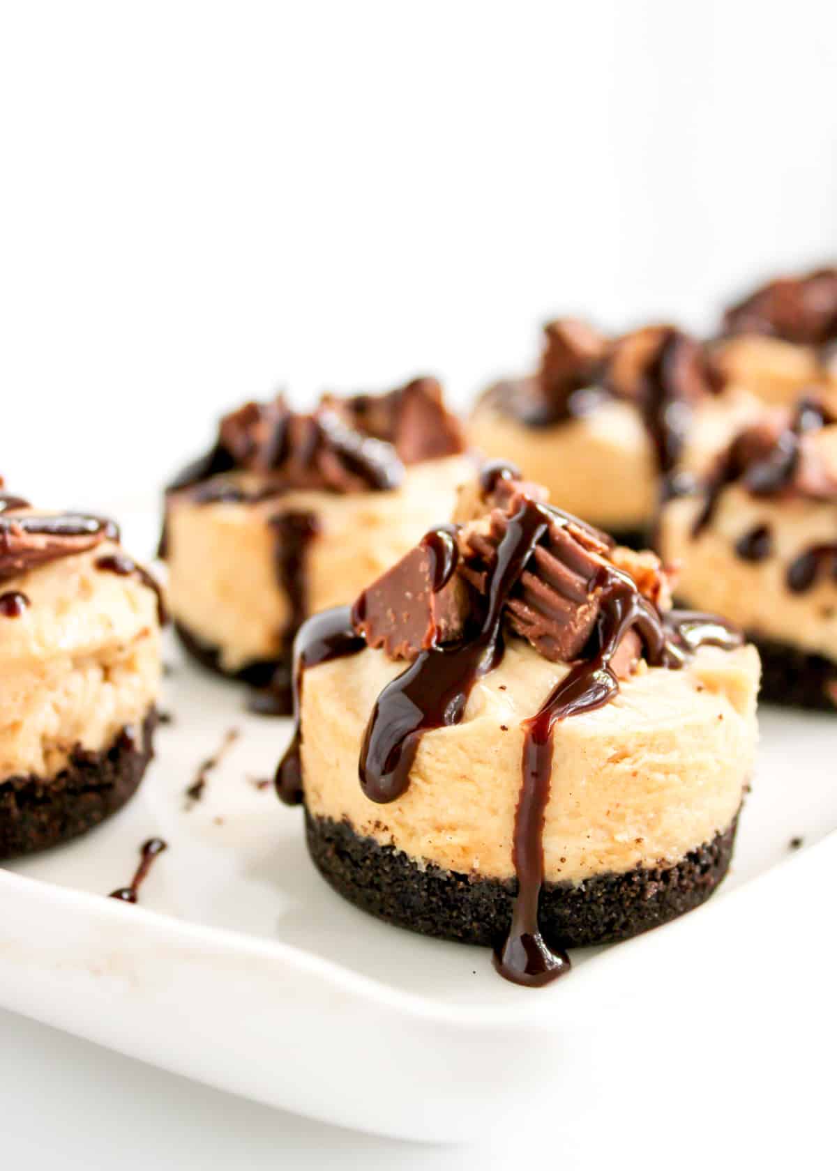 Close up of mini peanut butter pies on a white serving tray.