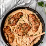 Parmesan Chicken Orzo in a skillet with a wood spoon with text overlay.