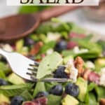 A spinach blueberry salad with text overlay.