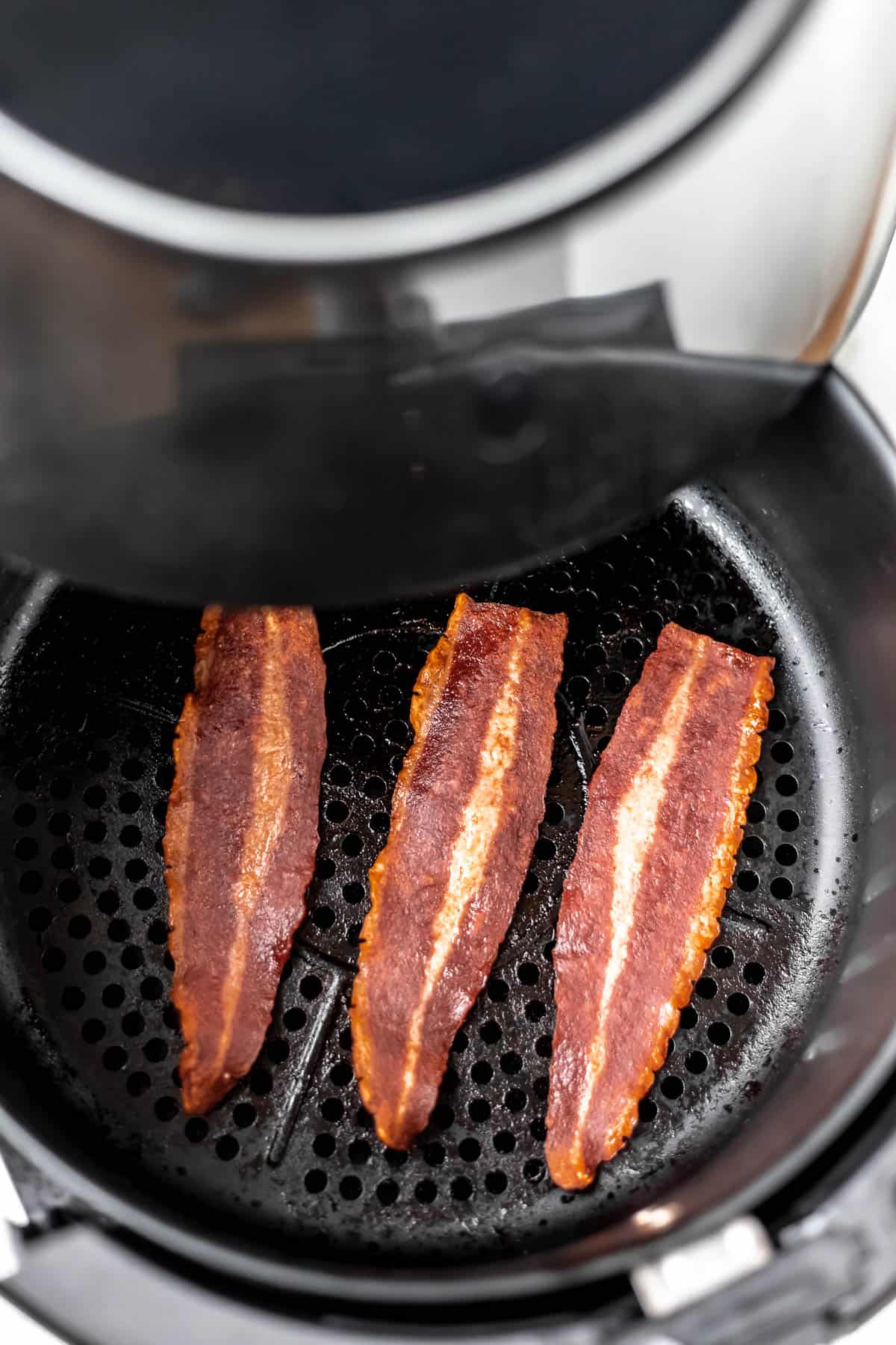 Cooked turkey bacon shown in an opened air fry basket.