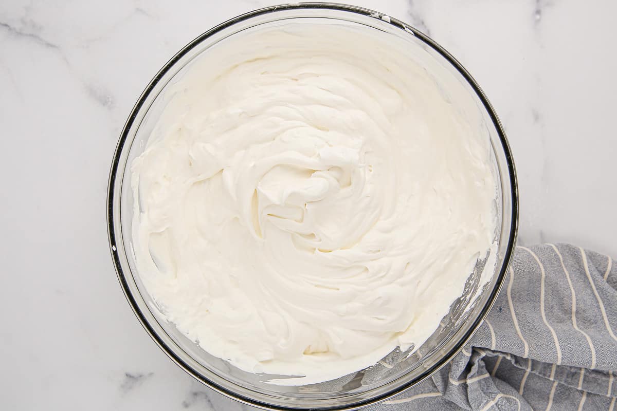 Cream cheese and whipped cream mixture in a glass bowl.