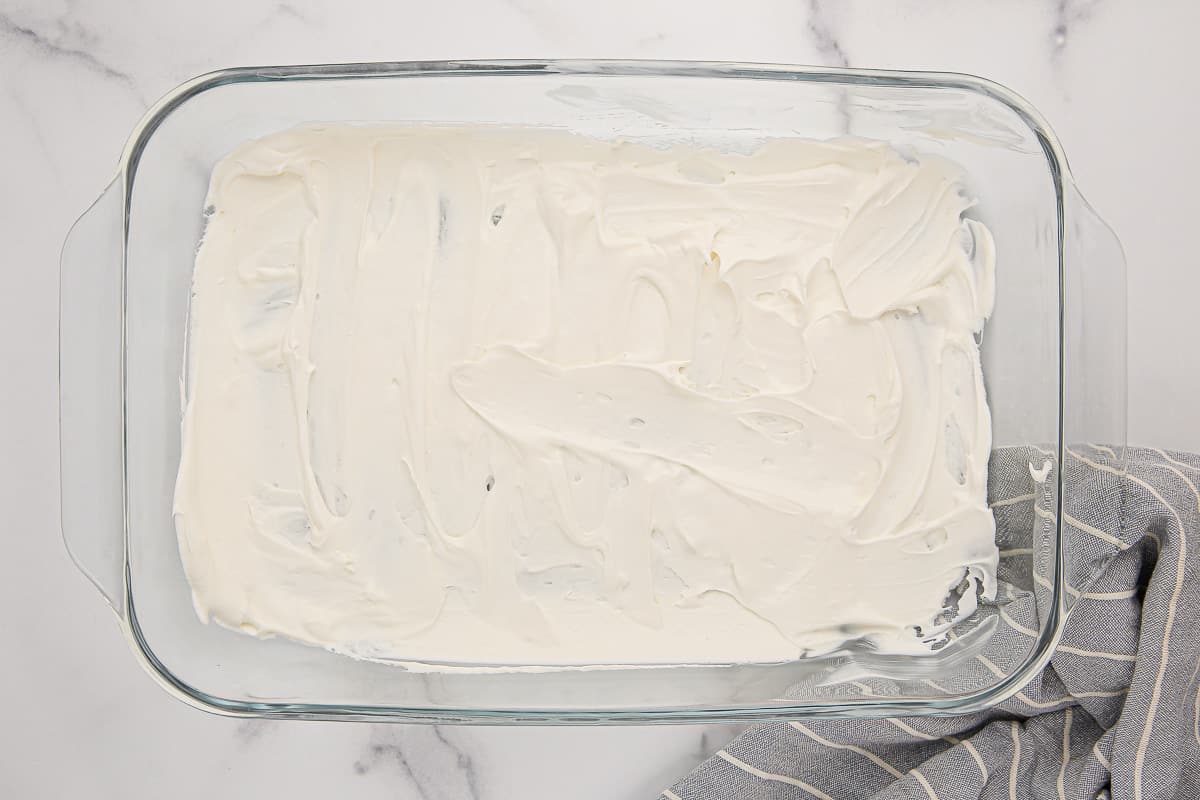 Cream cheese mixture in the bottom of a 9x13-inch baking dish.