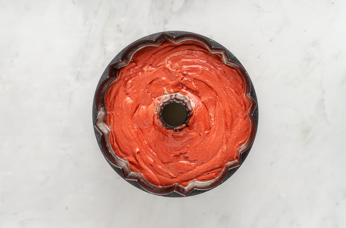 Red velvet pound cake batter in a bundt pan.