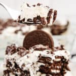 A forkful of Oreo Icebox Cake with the remainder of the serving on a plate with text overlay.