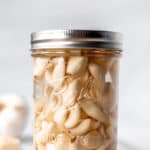 A jar of pickled garlic with text overlay.