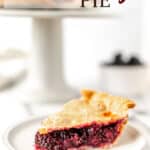 A slice of blackberry pie on a small plate with a cake stand in the background with text overlay.