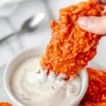 Buffalo chicken tenders being dipped into ranch dressing with text overlay.