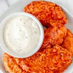 Buffalo chicken tenders with text overlay.