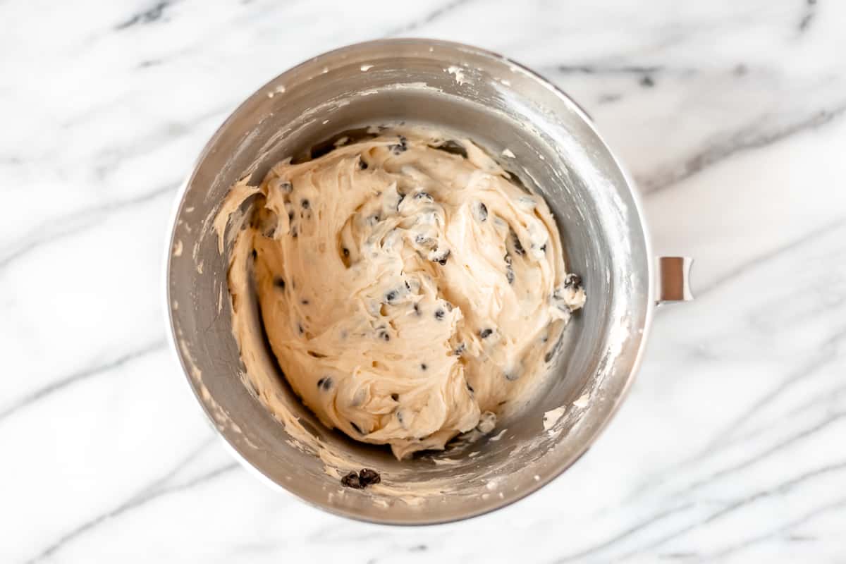 Pound cake batter with chocolate chips in it in a silver bowl.