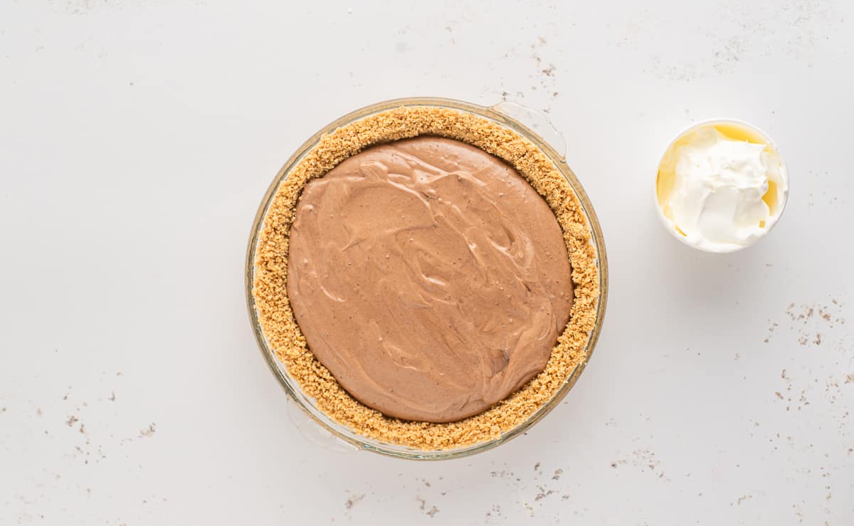 A pie made with graham cracker crust and a chocolate pudding filling.