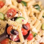 Greek pasta salad with text overlay.